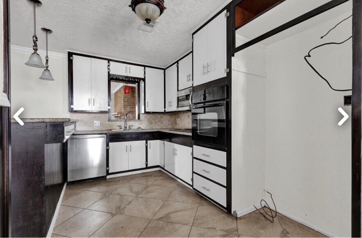 6009 Maple Street Houston, TX 77074 - Photo 5 of 11 a kitchen with stainless steel appliances granite countertop a sink and cabinets
