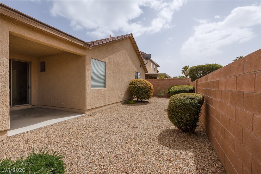 787 Rise Canyon Drive Henderson, NV 89052 - Photo 19 of 22 A private backyard oasis with low-maintenance gravel landscaping and a covered patio for outdoor enjoyment.