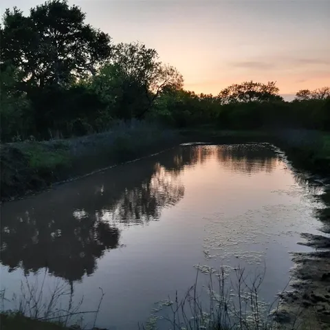 a view of a dry yard with mountains in the background