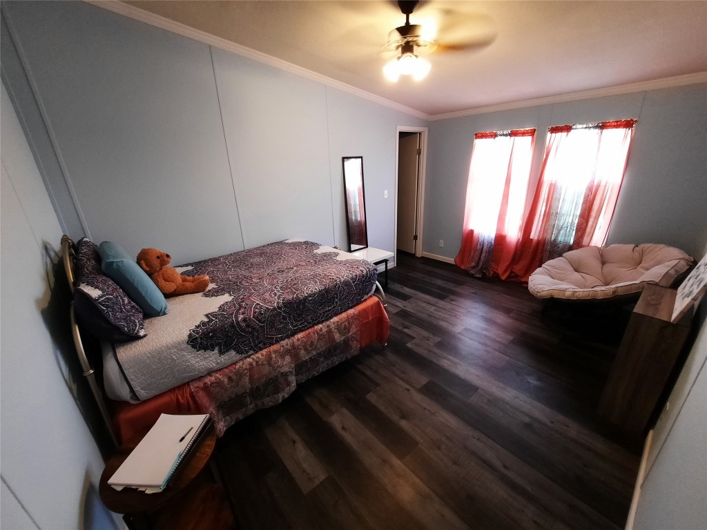 3160 Pettytown Road Dale, TX 78616 - Photo 32 of 37 a bed room with a bed and a chandelier