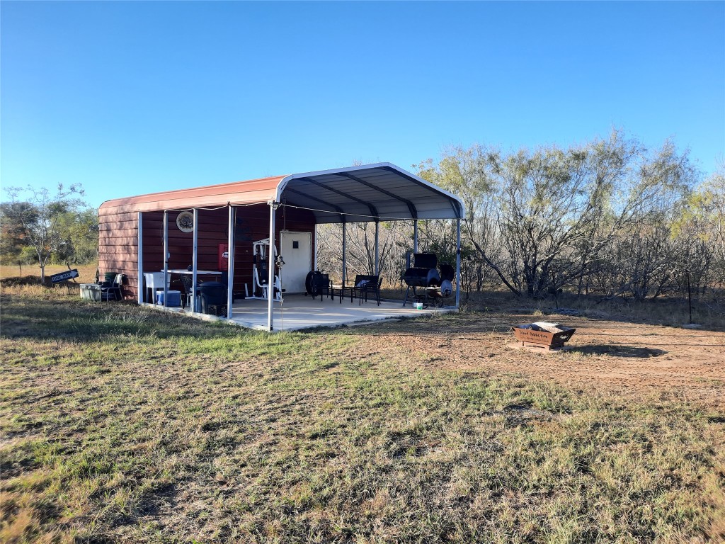 3160 Pettytown Road Dale, TX 78616 - Photo 4 of 37 a backyard of a house with barbeque oven table and chairs