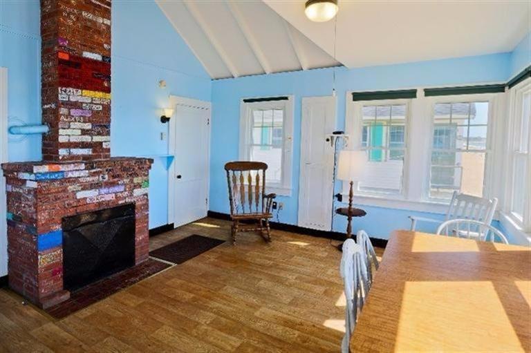 276 Shore Road, Unit 3 Truro, MA 02666 - Photo 7 of 12 a living room with furniture and a fireplace