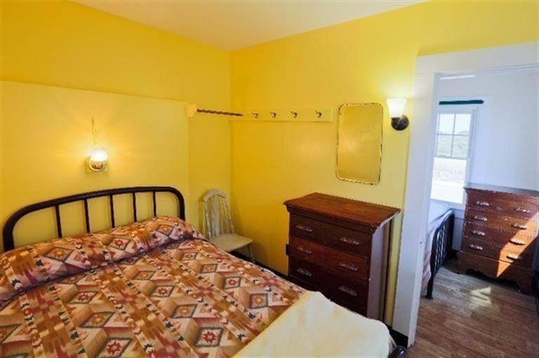 276 Shore Road, Unit 3 Truro, MA 02666 - Photo 9 of 12 a bedroom with a bed and wooden floor