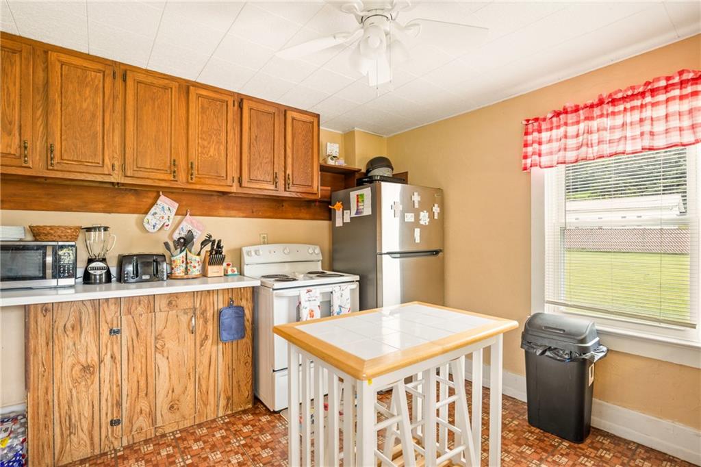 2030 Indian Head Road Indian Head, PA 15446 - Photo 9 of 26 a kitchen with refrigerator cabinets and a window