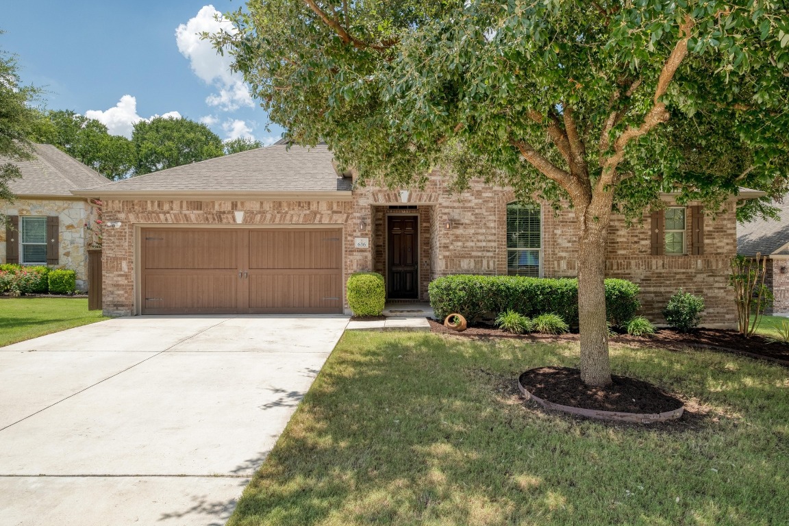 636 Trailside Bend Round Rock, TX 78665 - Photo 3 of 35 a front view of a house with a yard and garage