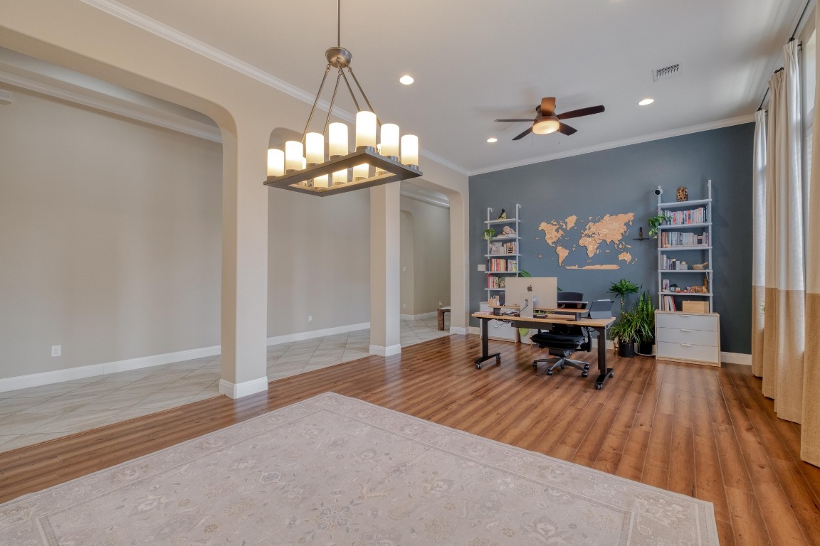 636 Trailside Bend Round Rock, TX 78665 - Photo 8 of 35 a view of a dining room with furniture a chandelier and wooden floor