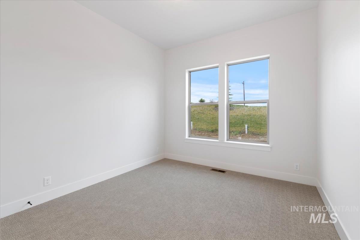 232 South Fusion Avenue Kuna, ID 83634 - Photo 20 of 30 Empty room featuring light carpet and baseboards