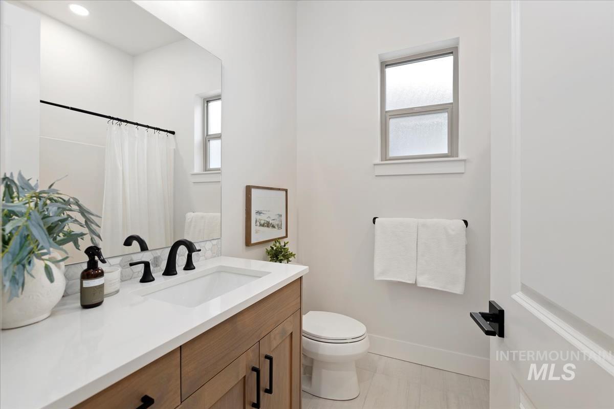 232 South Fusion Avenue Kuna, ID 83634 - Photo 21 of 30 Bathroom with vanity, a shower with curtain, and light tile patterned floors