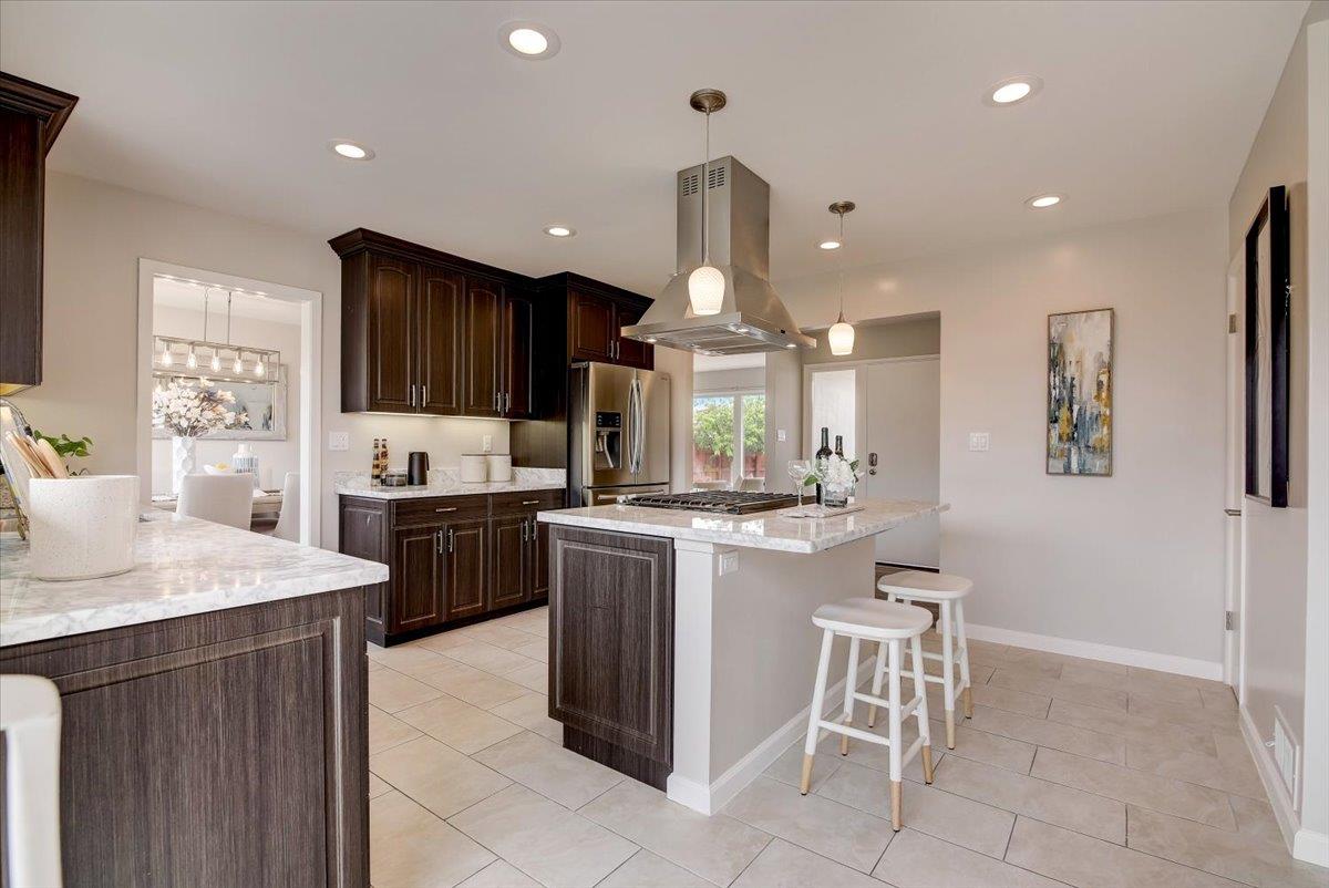 1209 Ridgewood Drive Millbrae, CA 94030 - Photo 16 of 59 a kitchen with a sink cabinets and wooden floor