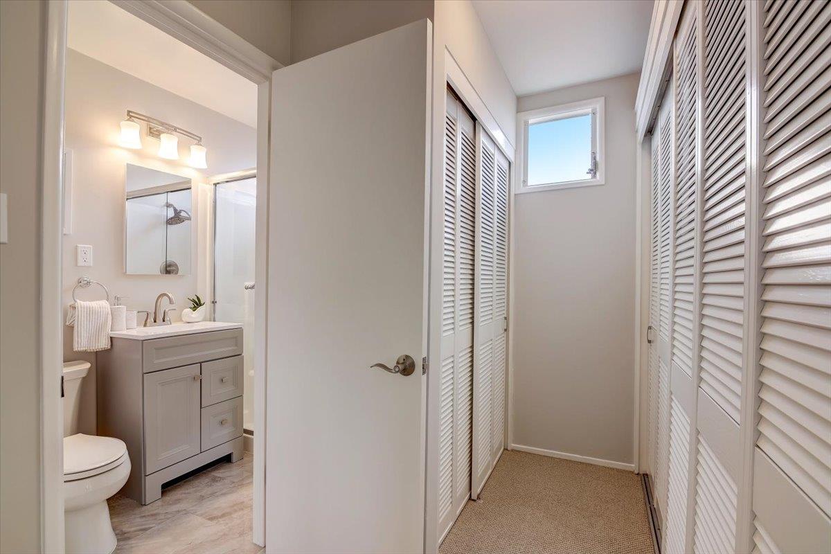 1209 Ridgewood Drive Millbrae, CA 94030 - Photo 24 of 59 a bathroom with a granite countertop toilet a sink and a mirror