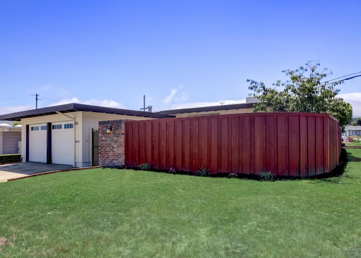 1209 Ridgewood Drive Millbrae, CA 94030 - Photo 56 of 59 a view of a backyard with potted plants and wooden fence
