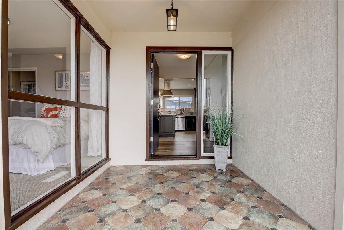 1209 Ridgewood Drive Millbrae, CA 94030 - Photo 57 of 59 a view of a hallway with wooden floor and a living room