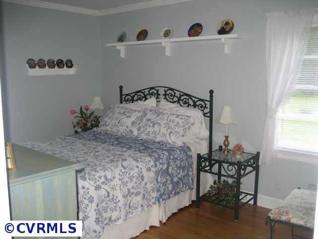300 Monath Road Richmond, VA 23236 - Photo 4 of 10 a bedroom with a bed and a table in it