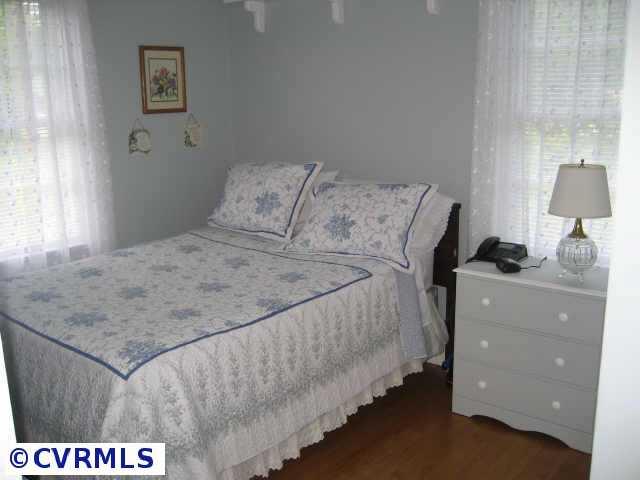 300 Monath Road Richmond, VA 23236 - Photo 5 of 10 a bedroom with a bed and a lamp on table