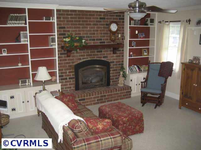 300 Monath Road Richmond, VA 23236 - Photo 8 of 10 a living room with furniture a flat screen tv and a fireplace