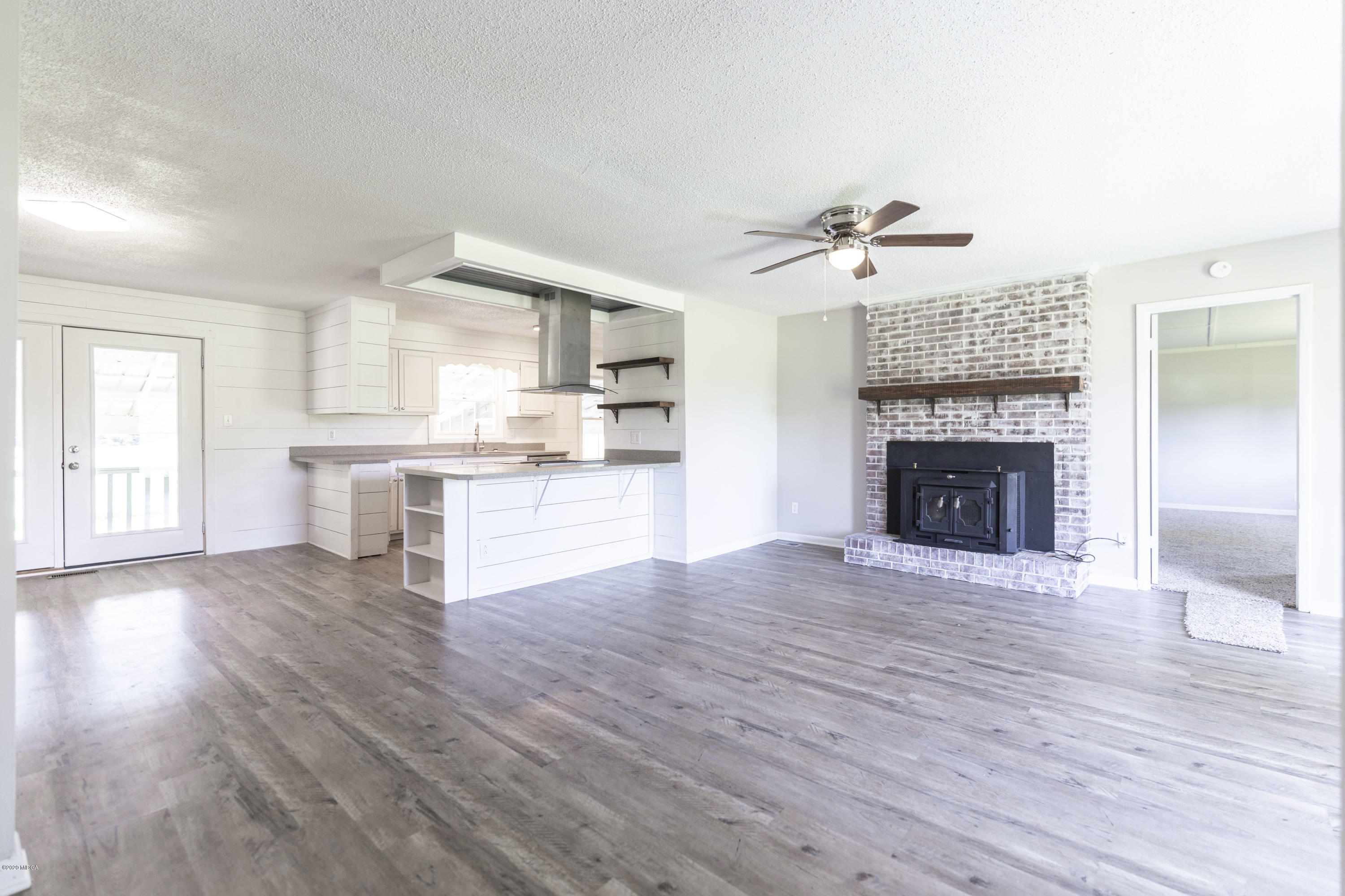246 Allred Road Byron, GA 31008 - Photo 11 of 53 wooden floor fireplace and windows in an empty room