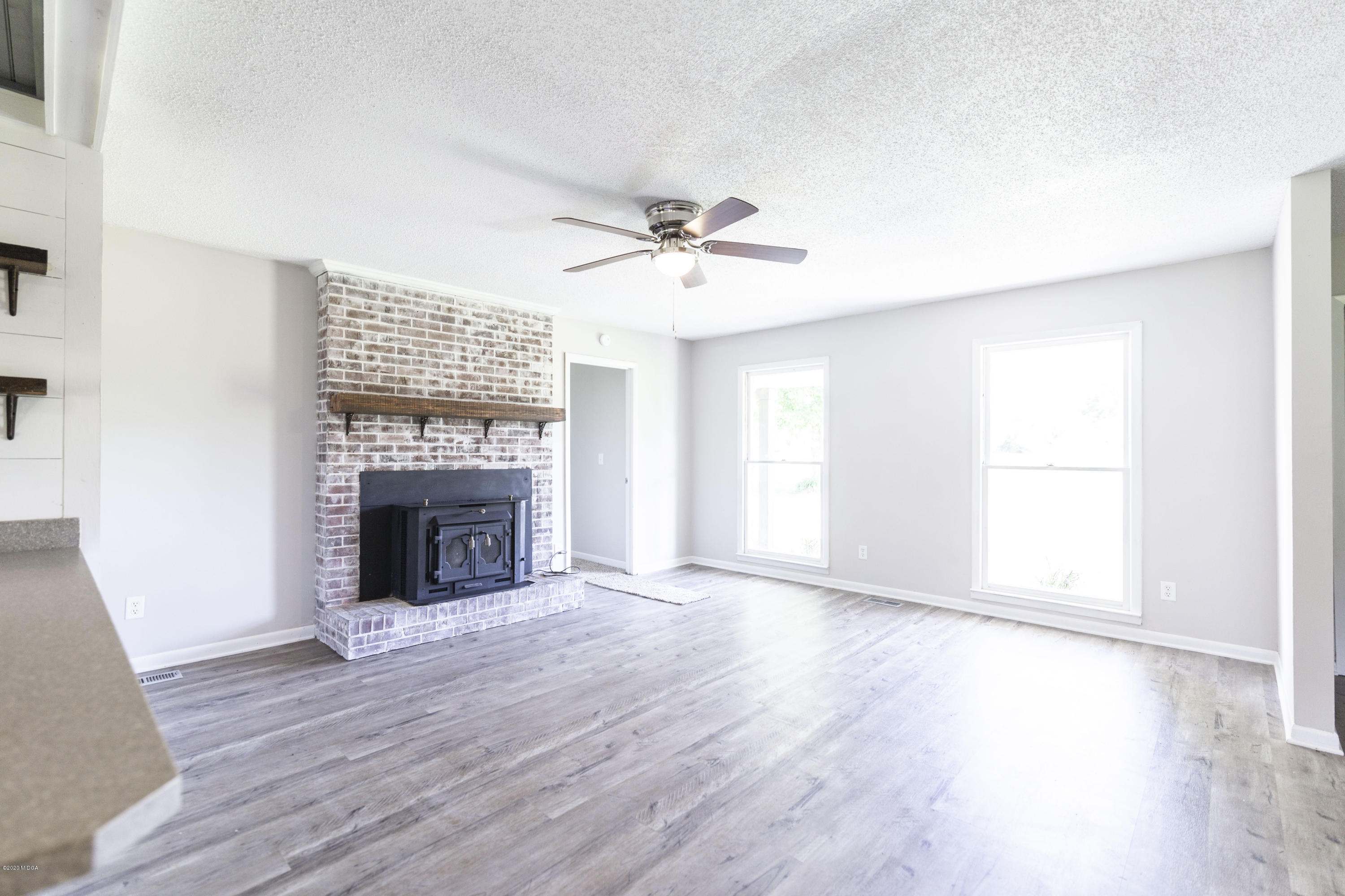 246 Allred Road Byron, GA 31008 - Photo 13 of 53 an empty room with windows fireplace and a sink