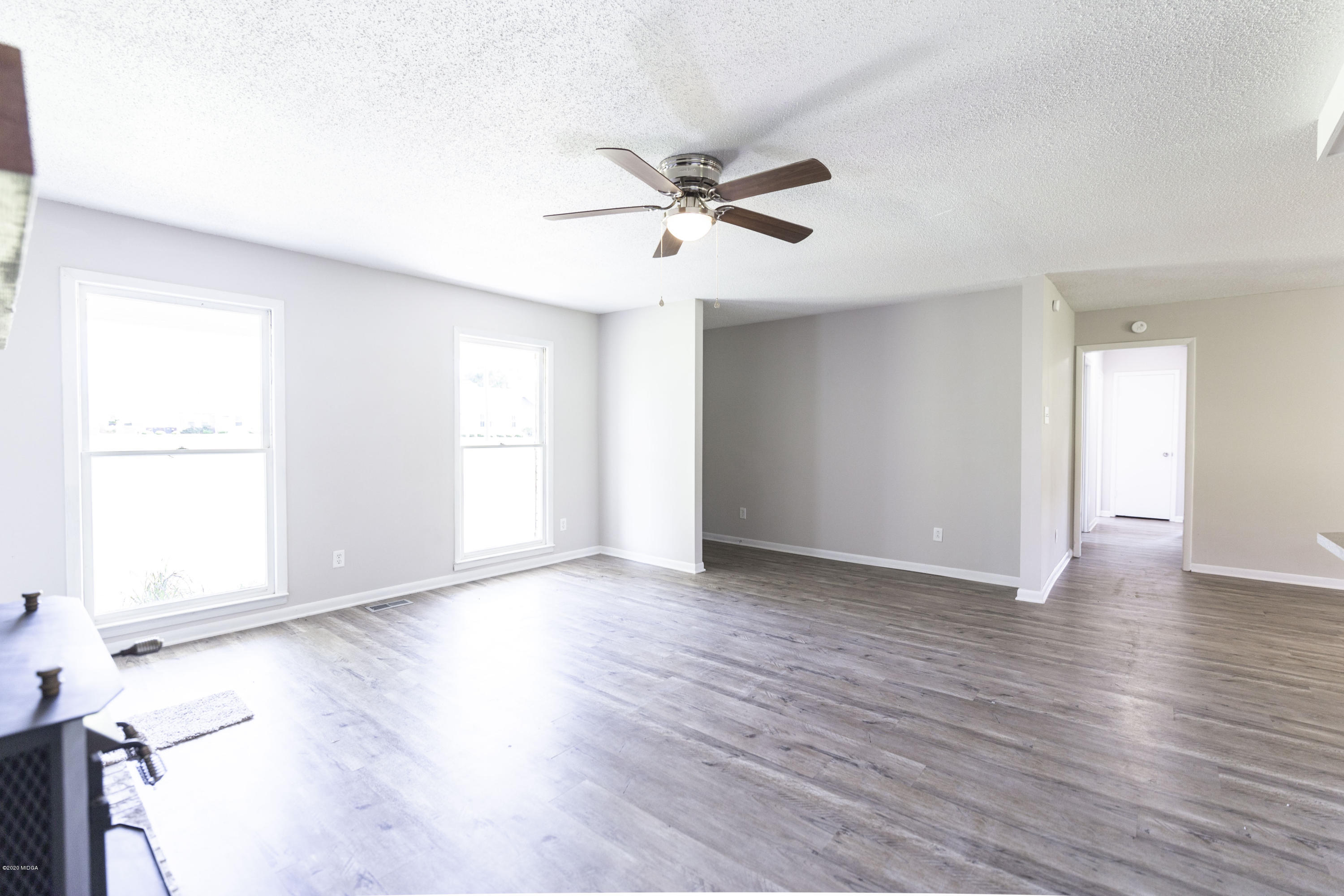 246 Allred Road Byron, GA 31008 - Photo 14 of 53 a view of an empty room with wooden floor and a window
