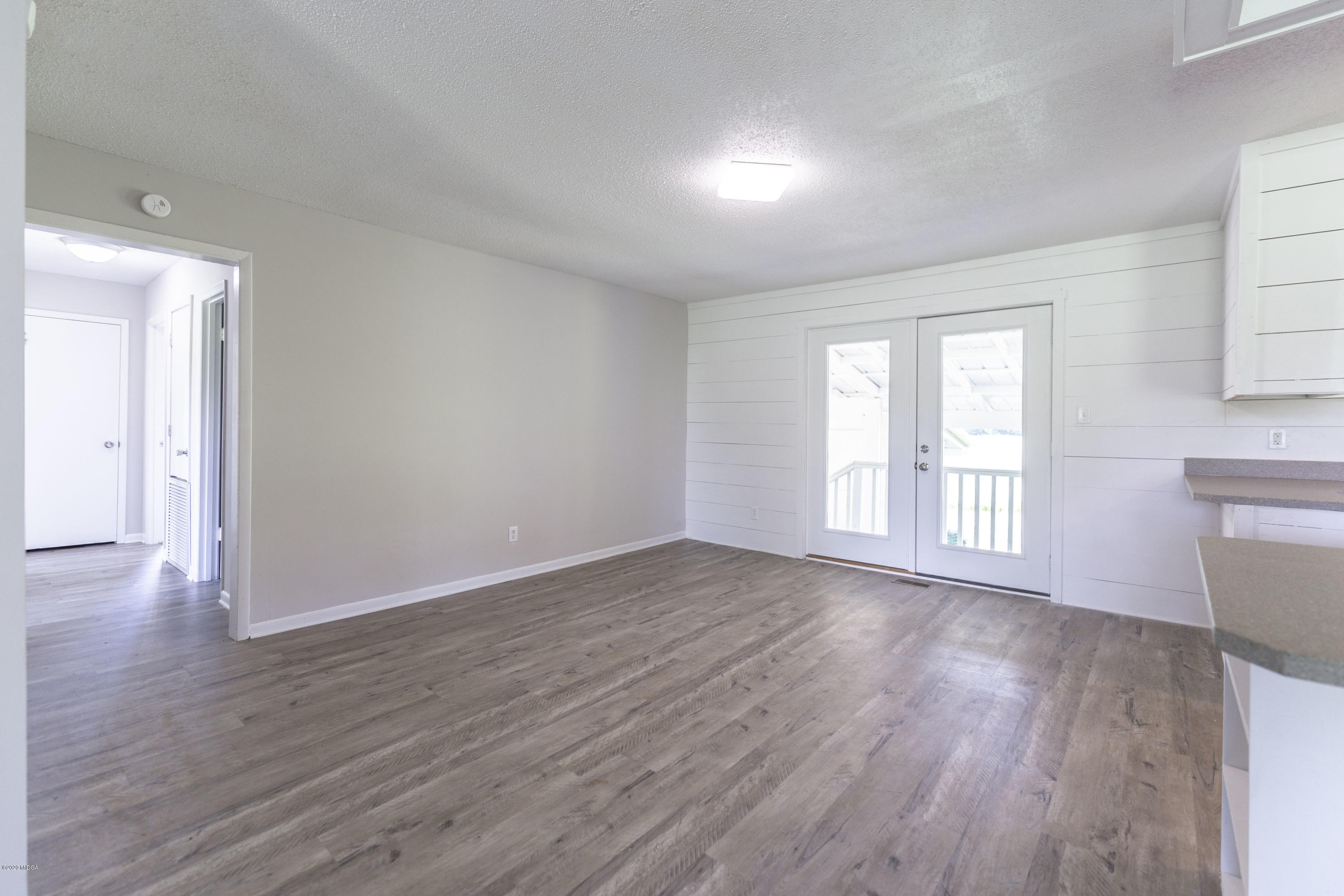 246 Allred Road Byron, GA 31008 - Photo 17 of 53 a view of an empty room with wooden floor and a window