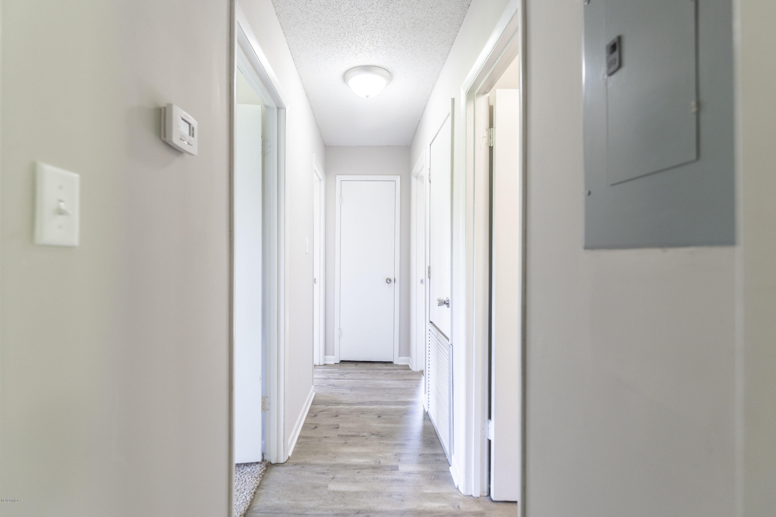 246 Allred Road Byron, GA 31008 - Photo 26 of 53 a view of a hallway with wooden floor and a bathroom