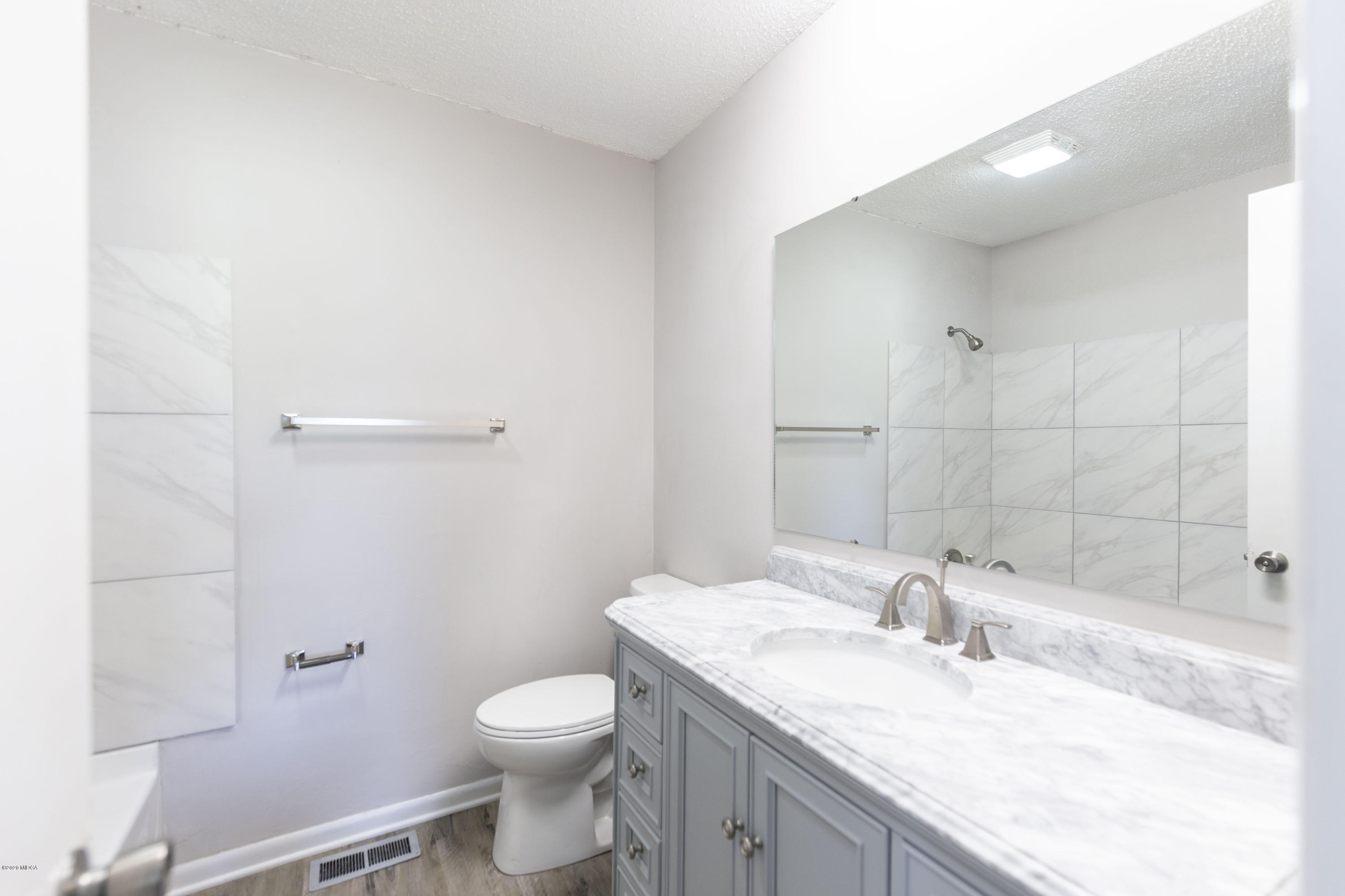 246 Allred Road Byron, GA 31008 - Photo 27 of 53 a bathroom with a granite countertop sink a toilet and shower