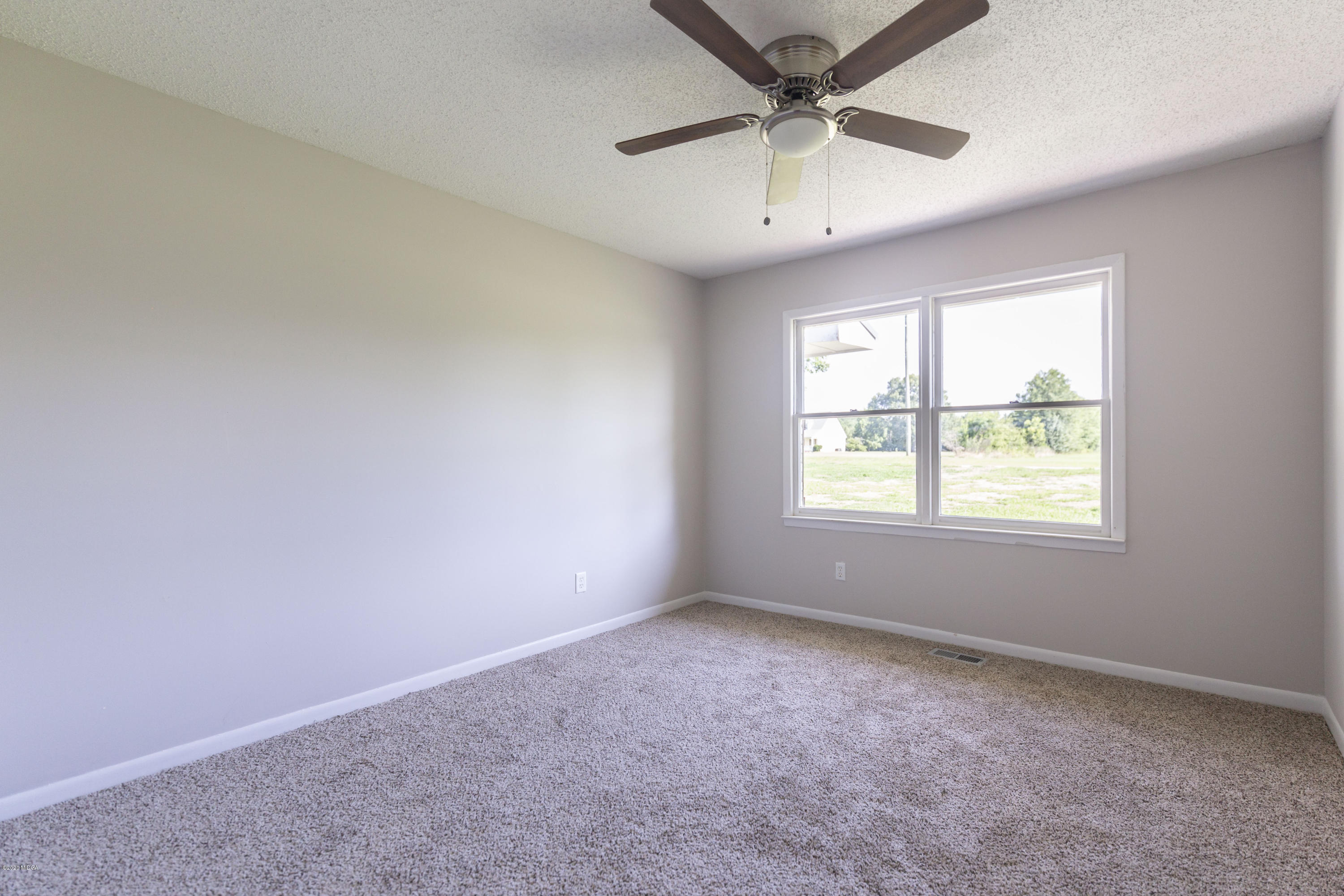 246 Allred Road Byron, GA 31008 - Photo 29 of 53 an empty room with a window and a fan