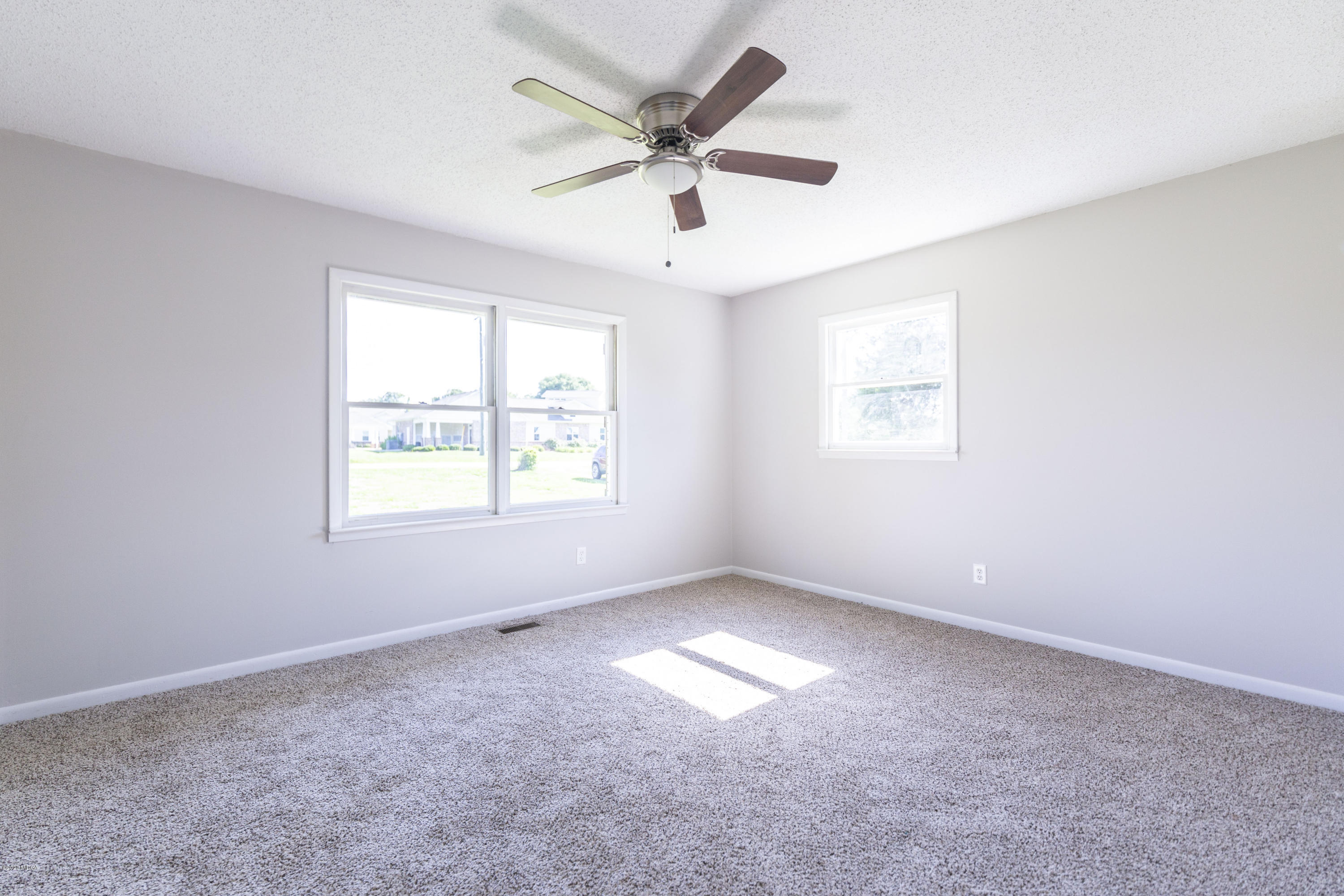 246 Allred Road Byron, GA 31008 - Photo 31 of 53 an empty room with windows and fan