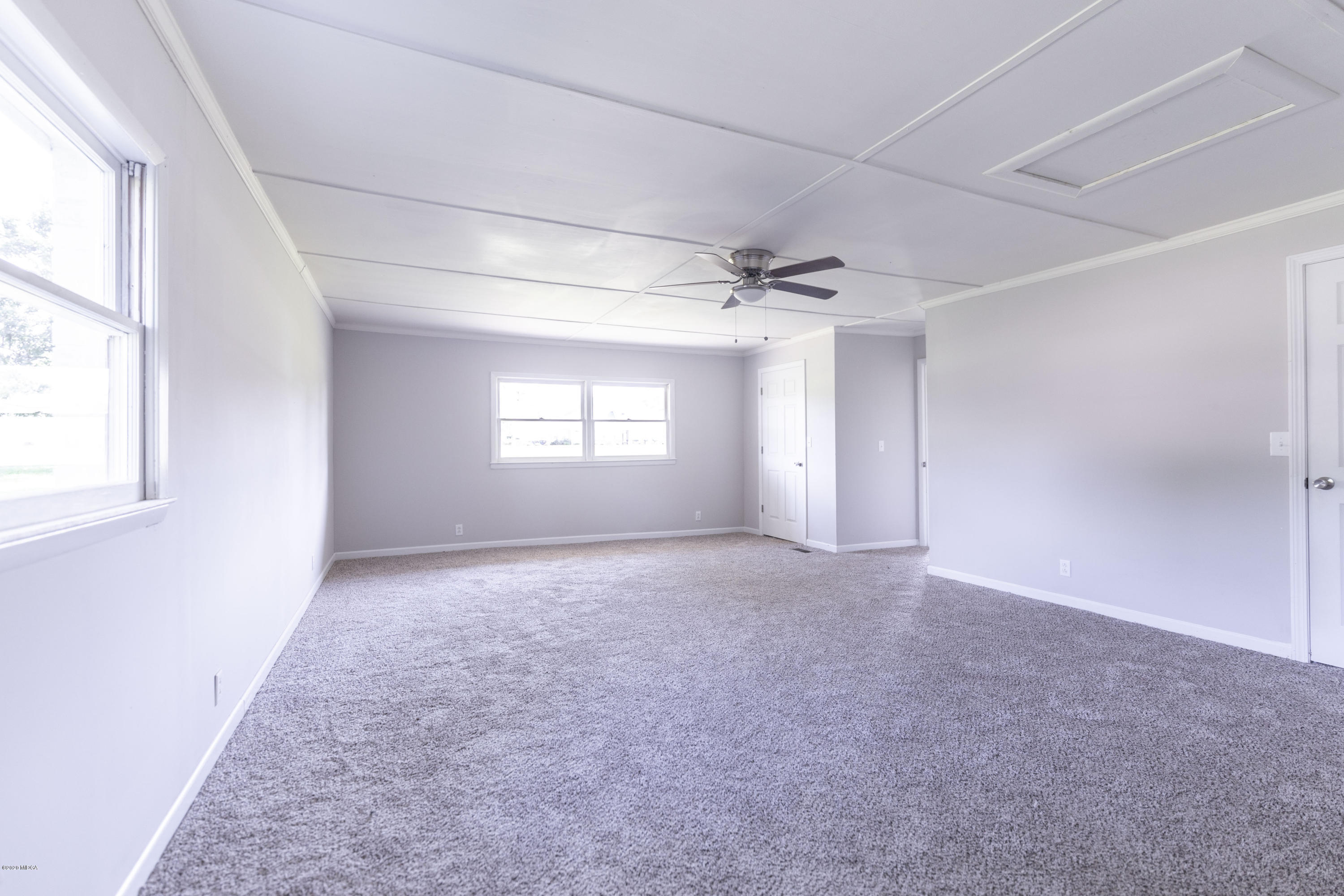 246 Allred Road Byron, GA 31008 - Photo 38 of 53 an empty room with windows and chandelier fan