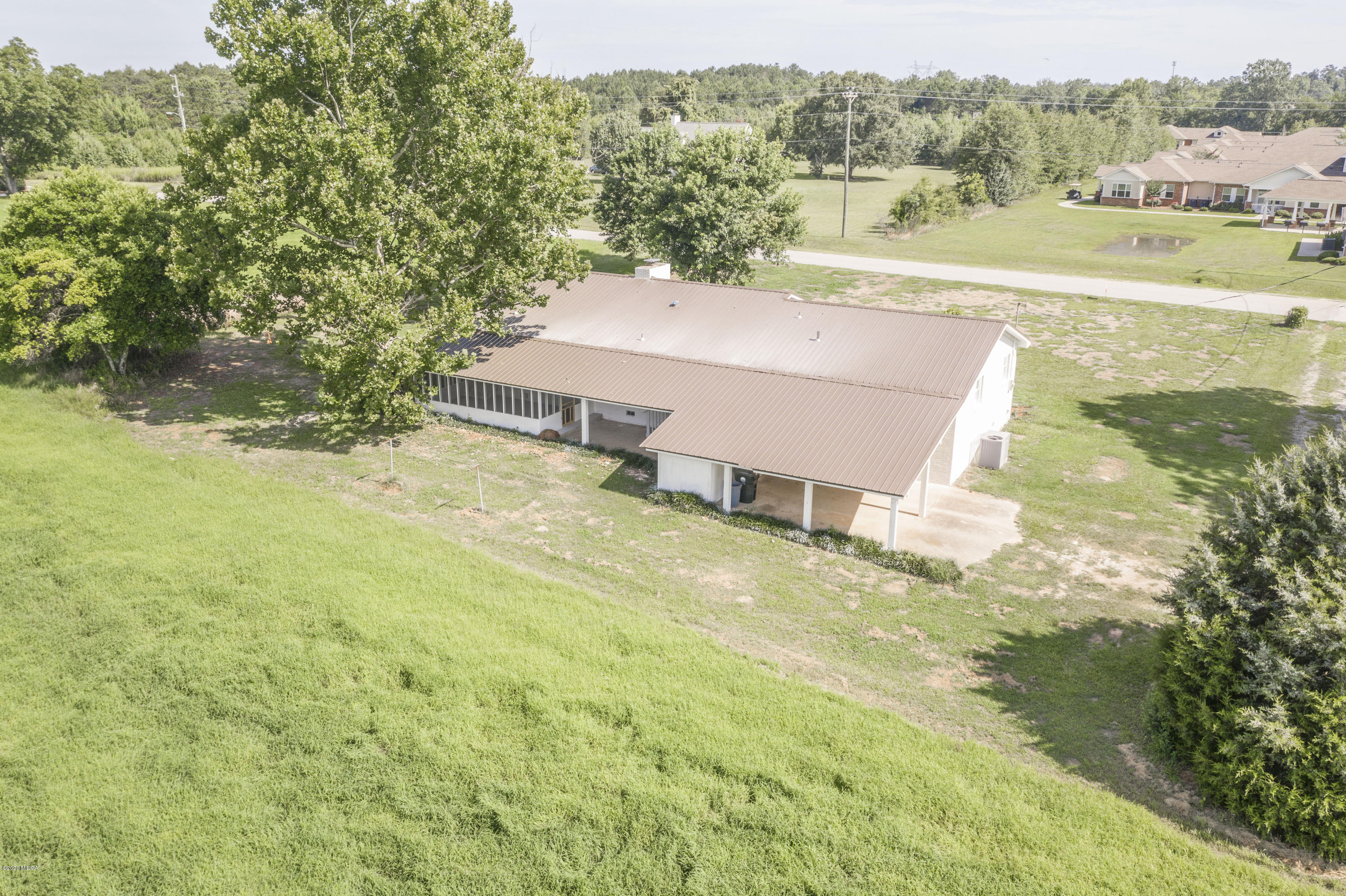 246 Allred Road Byron, GA 31008 - Photo 50 of 53 an aerial view of residential houses with outdoor space and trees