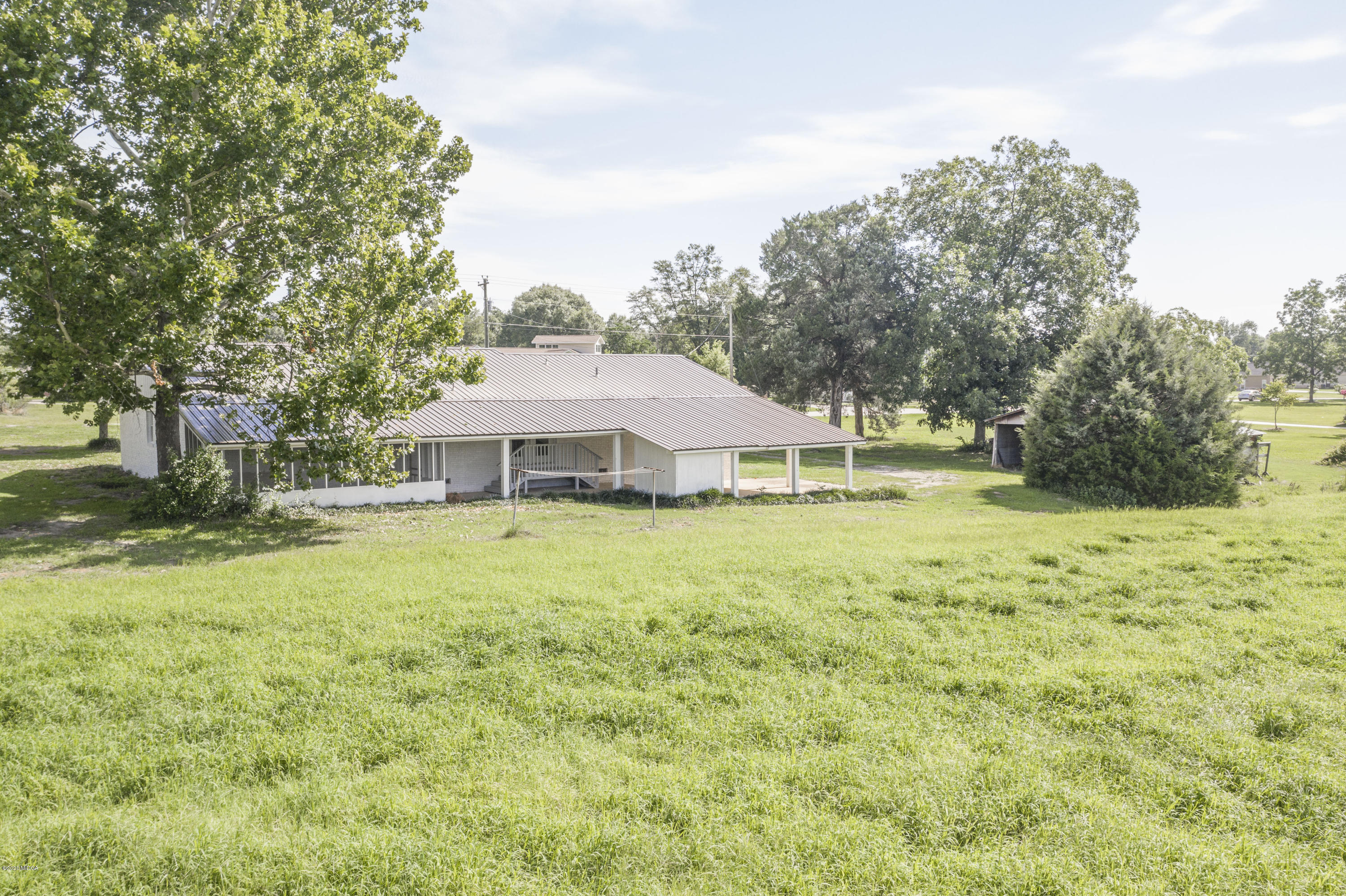 246 Allred Road Byron, GA 31008 - Photo 51 of 53 a backyard of a house with large trees and a big yard