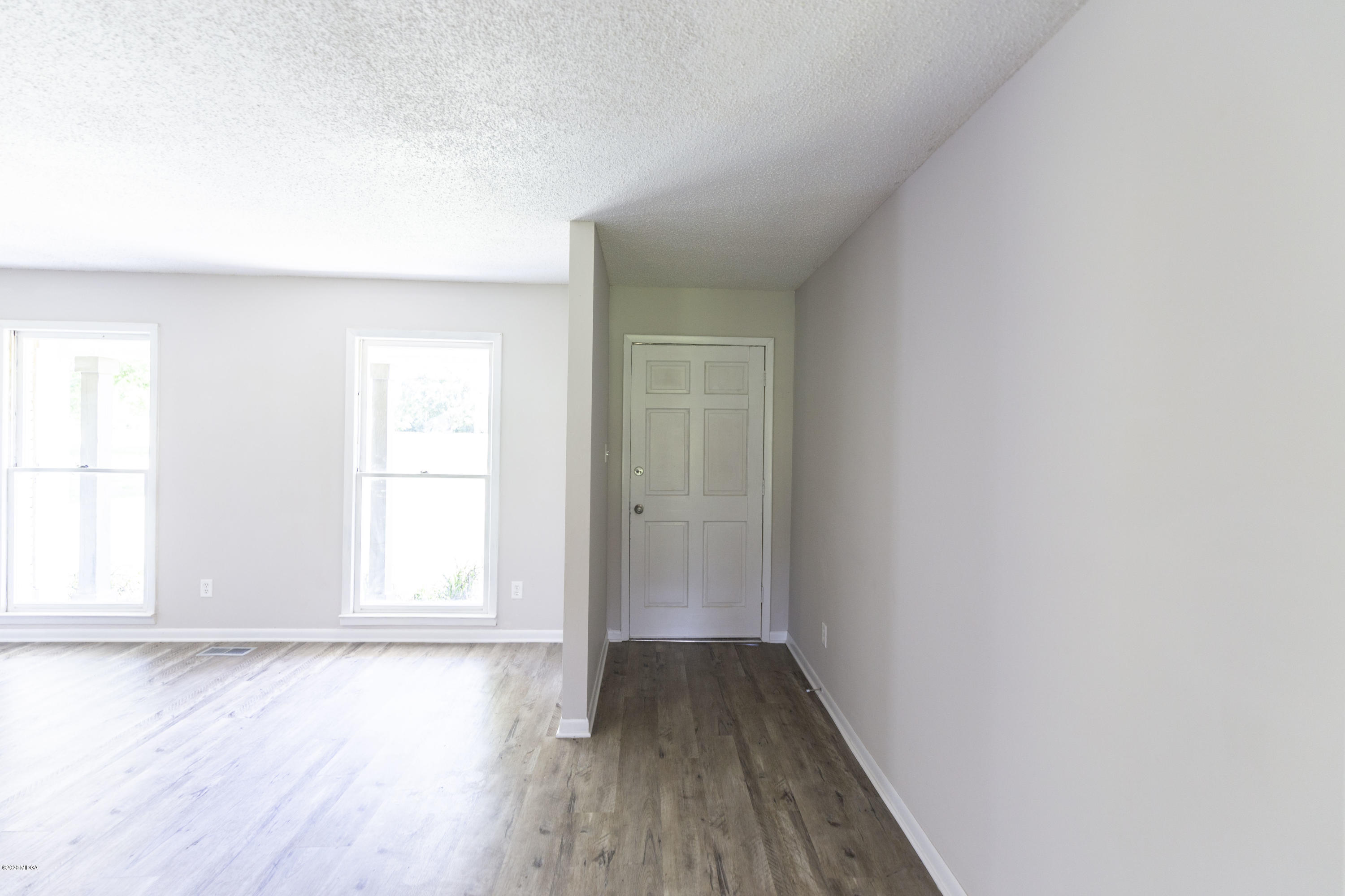 246 Allred Road Byron, GA 31008 - Photo 10 of 53 an empty room with wooden floor and windows