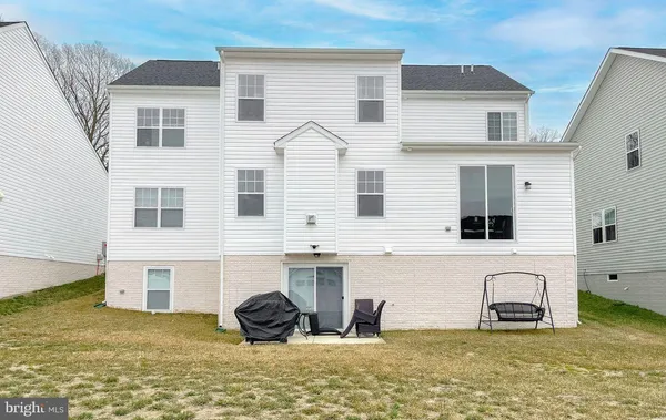 a view of a house with swimming pool and furniture
