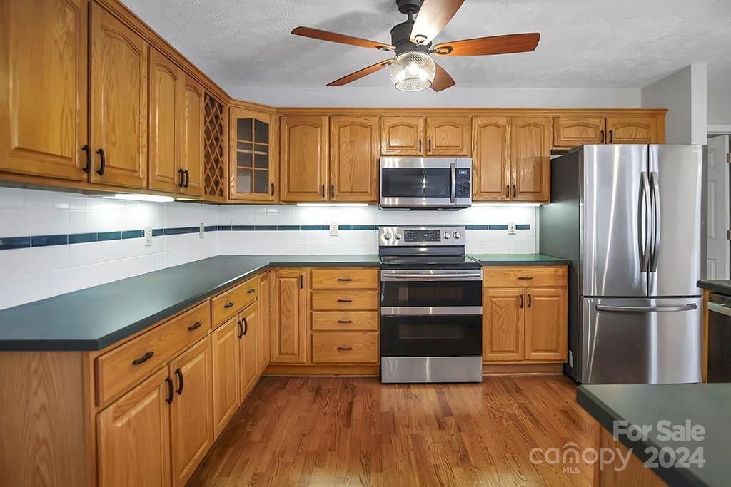 210 Harbor Point Drive Cherryville, NC 28021 - Photo 15 of 45 a kitchen with stainless steel appliances granite countertop a refrigerator a stove top oven a sink and dishwasher