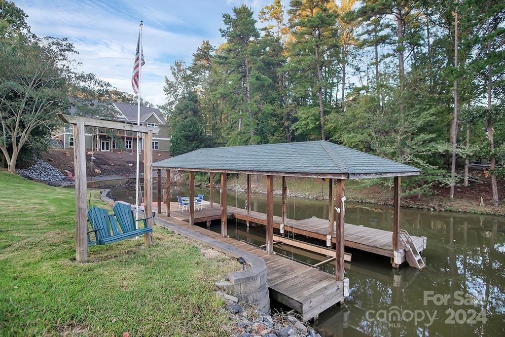 210 Harbor Point Drive Cherryville, NC 28021 - Photo 30 of 45 a view of a patio with table and chairs under an umbrella