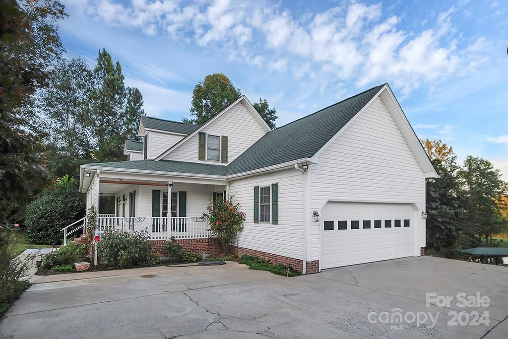 210 Harbor Point Drive Cherryville, NC 28021 - Photo 35 of 45 a view of a white house with a yard and potted plants