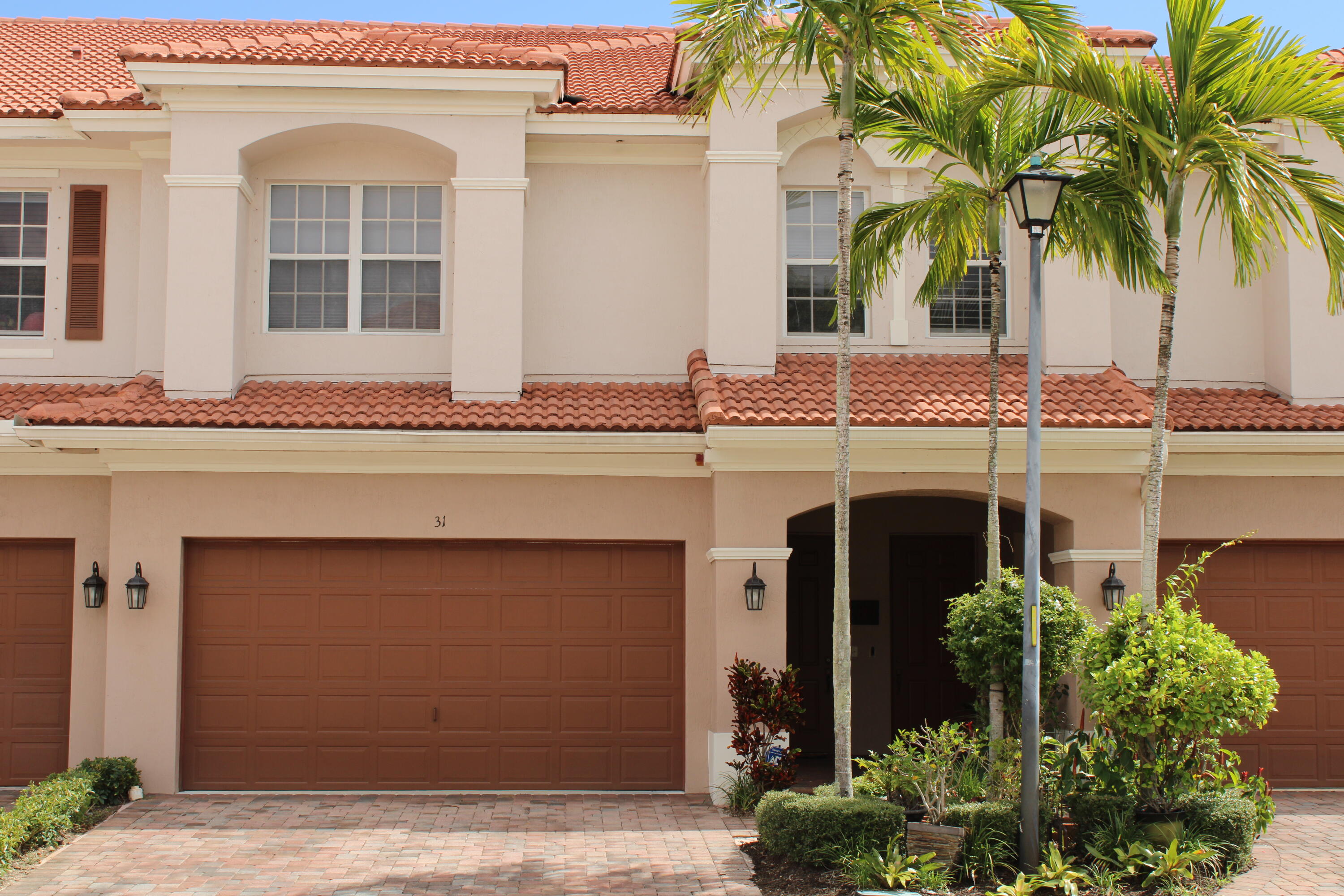 31 Beechdale Lane Boynton Beach, FL 33426 - Photo 1 of 26 a front view of a house with a garden