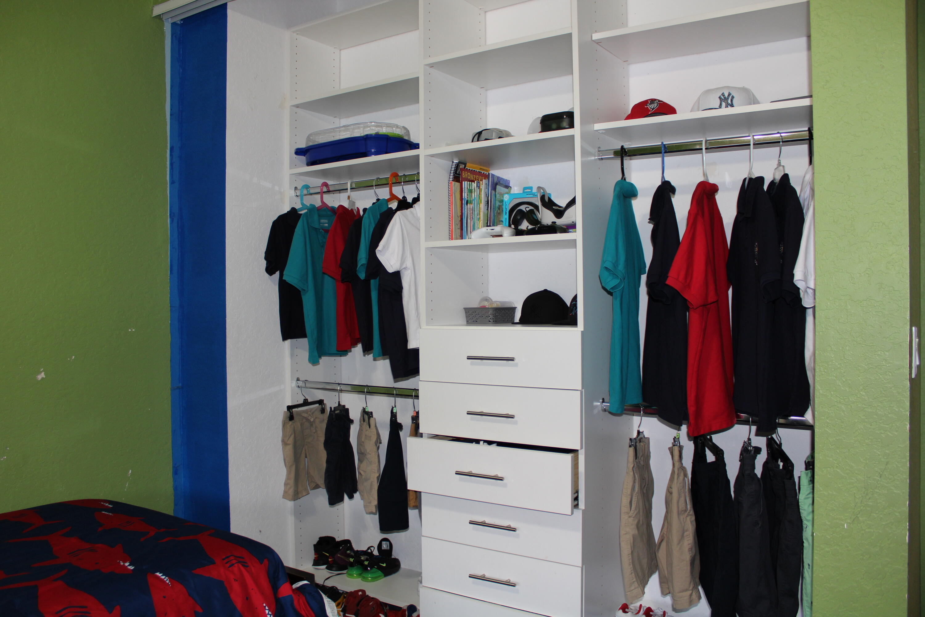 31 Beechdale Lane Boynton Beach, FL 33426 - Photo 12 of 26 a view of walk in closet with clothes and shoes