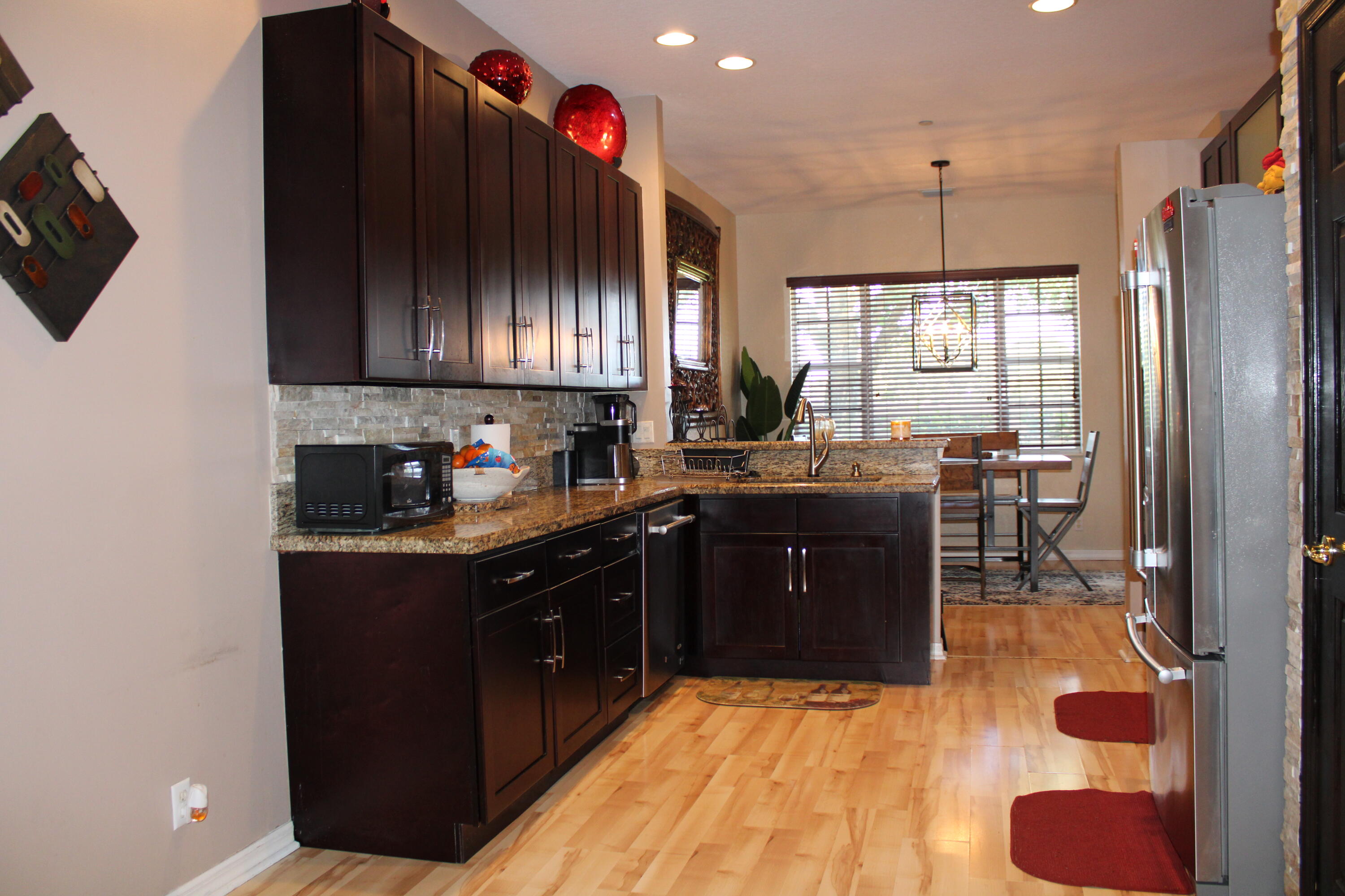 31 Beechdale Lane Boynton Beach, FL 33426 - Photo 3 of 26 a kitchen with a sink cabinets and window