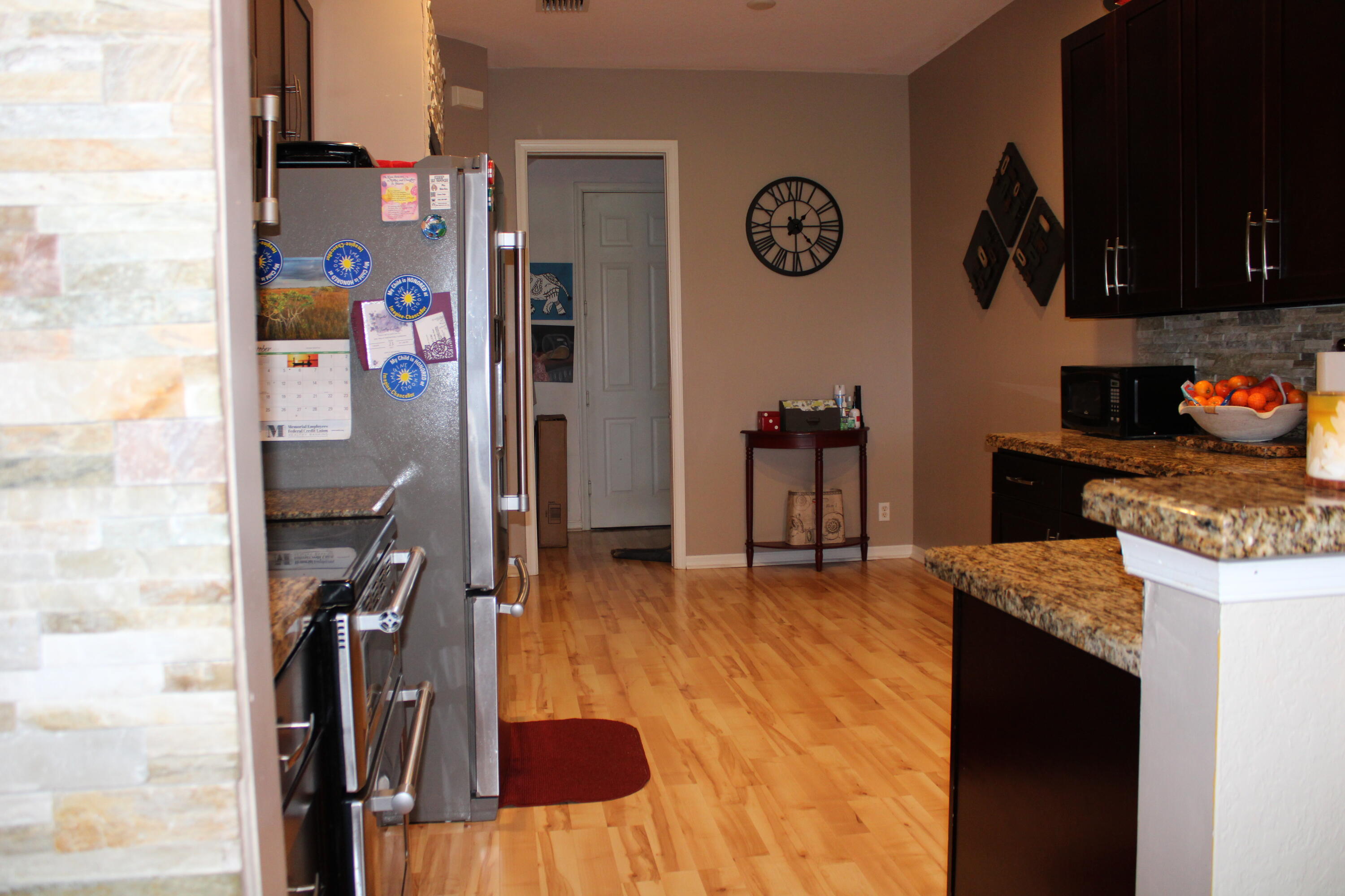 31 Beechdale Lane Boynton Beach, FL 33426 - Photo 4 of 26 a kitchen with a refrigerator and a stove top oven