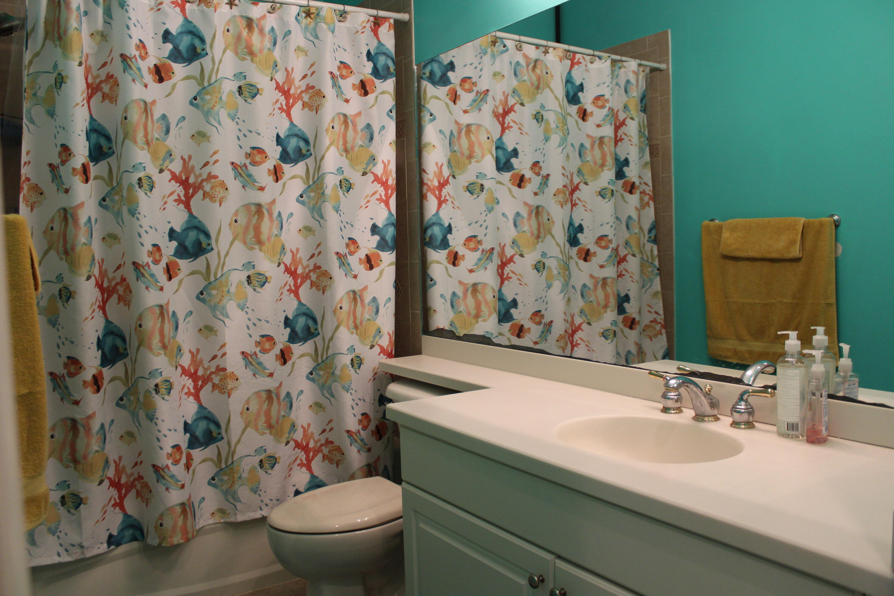 31 Beechdale Lane Boynton Beach, FL 33426 - Photo 9 of 26 a bathroom with a sink and mirror with toilet