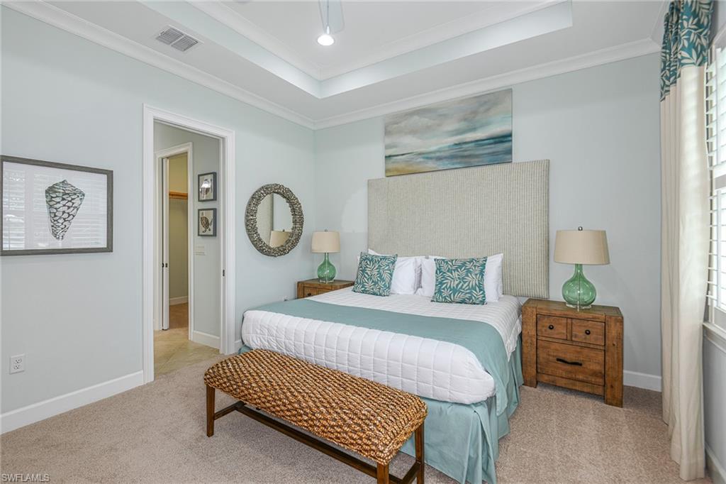 5764 Elbow Avenue Naples, FL 34113 - Photo 16 of 48 a bedroom with a bed and a chandelier