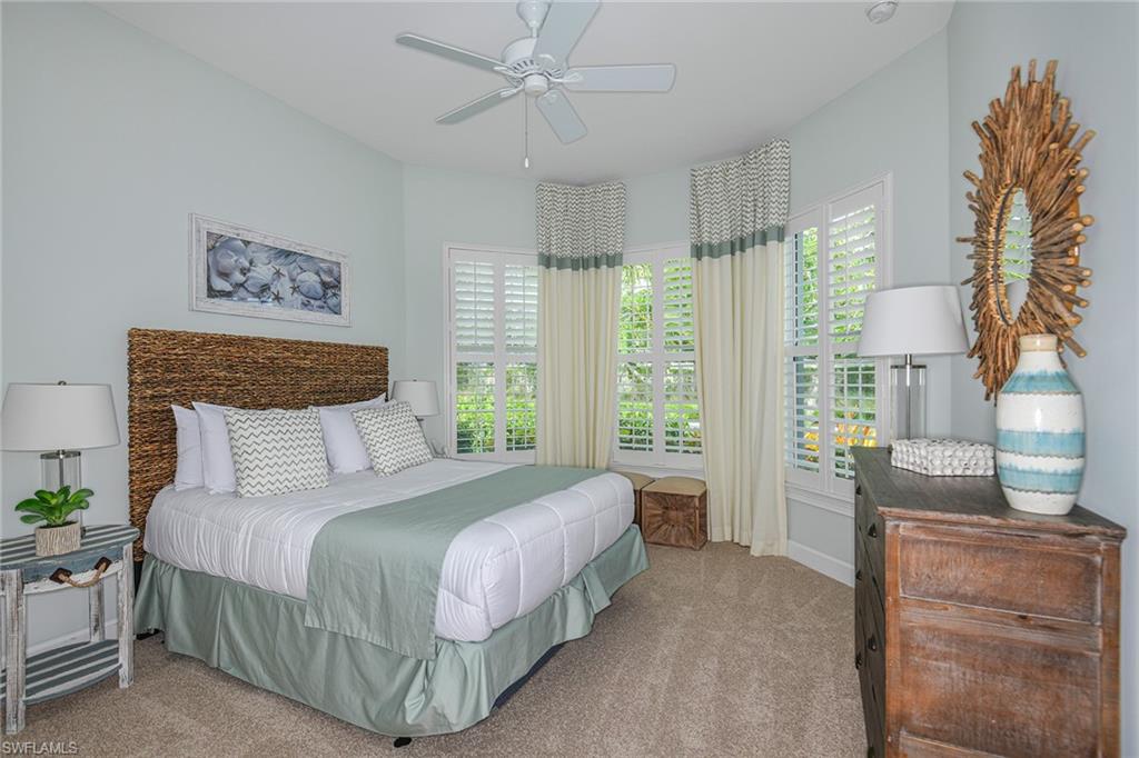 5764 Elbow Avenue Naples, FL 34113 - Photo 20 of 48 a bedroom with a large bed and a window