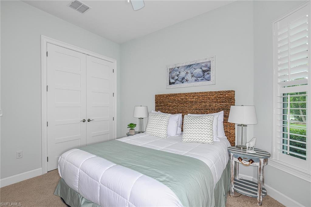 5764 Elbow Avenue Naples, FL 34113 - Photo 21 of 48 a bedroom with a large bed and a window