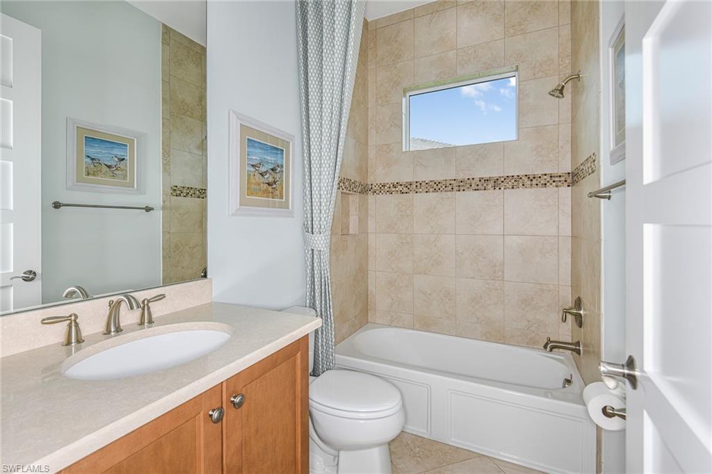 5764 Elbow Avenue Naples, FL 34113 - Photo 22 of 48 a bathroom with a granite countertop sink a toilet and shower