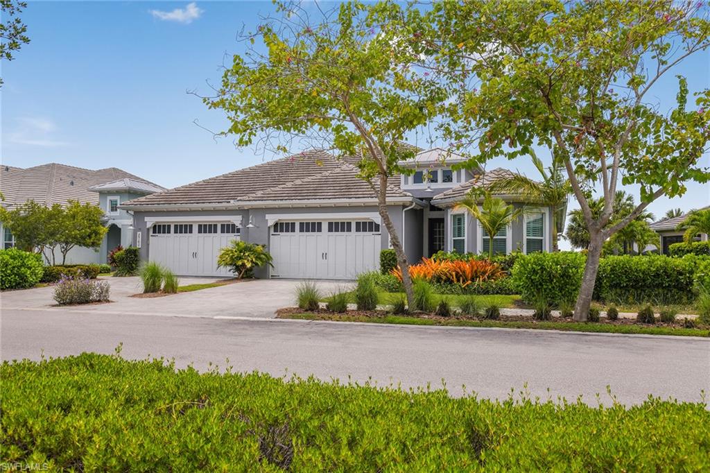 5764 Elbow Avenue Naples, FL 34113 - Photo 30 of 48 a front view of a house with a garden
