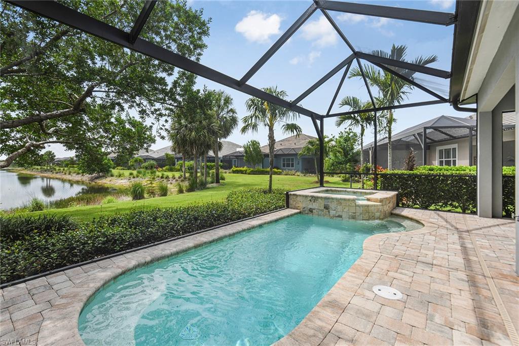 5764 Elbow Avenue Naples, FL 34113 - Photo 3 of 48 a view of a swimming pool with a patio