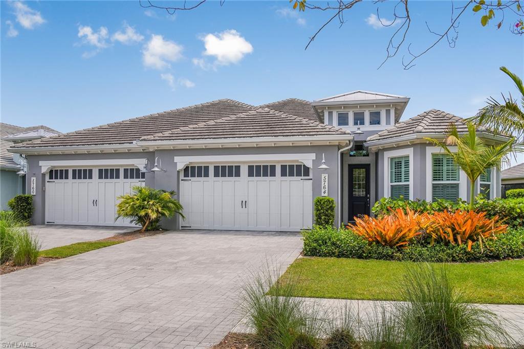 5764 Elbow Avenue Naples, FL 34113 - Photo 31 of 48 a front view of a house with a garden and plants