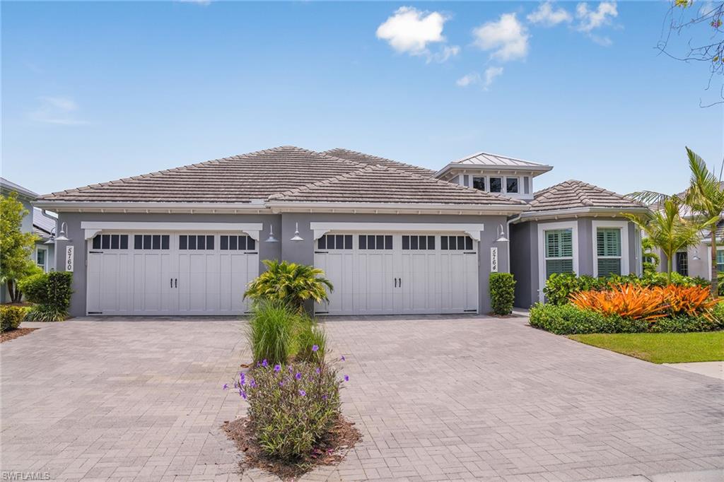 5764 Elbow Avenue Naples, FL 34113 - Photo 32 of 48 a front view of a house with garden
