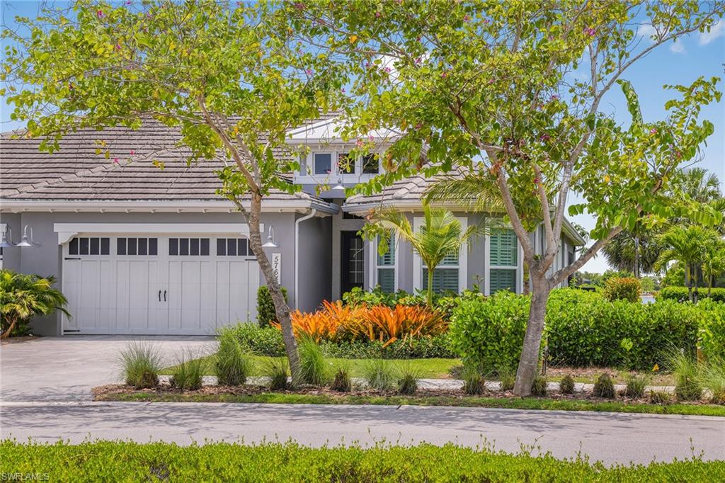 5764 Elbow Avenue Naples, FL 34113 - Photo 33 of 48 a front view of a house with a garden