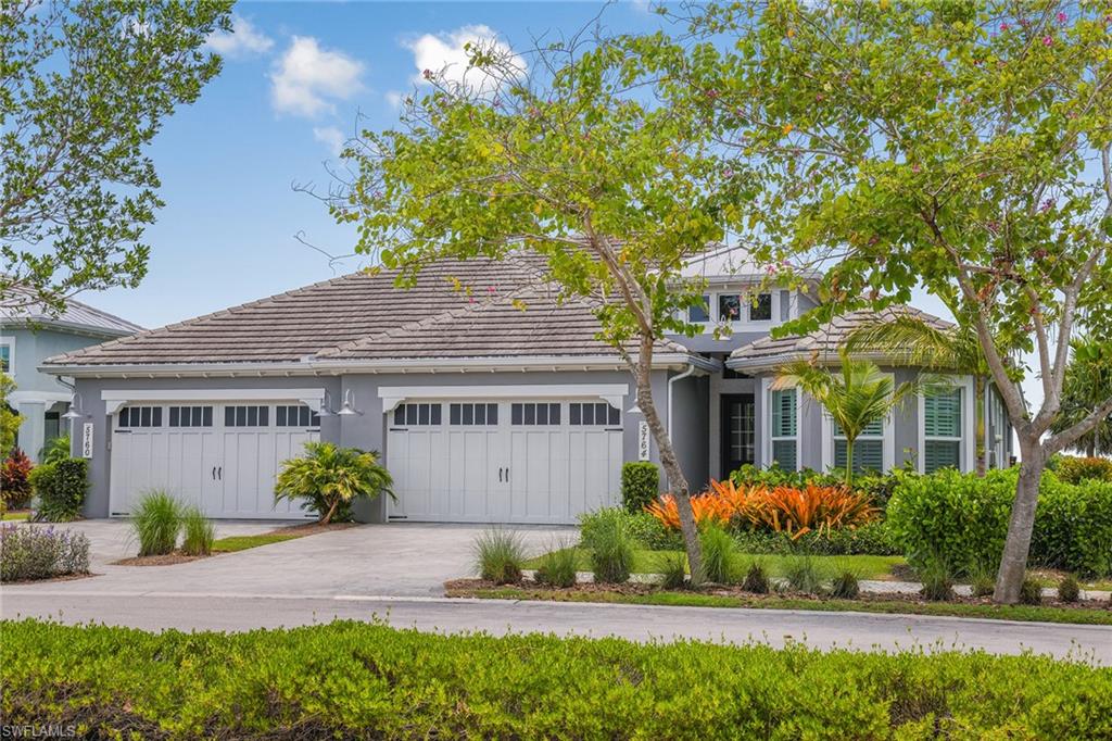 5764 Elbow Avenue Naples, FL 34113 - Photo 36 of 48 a front view of a house with a garden